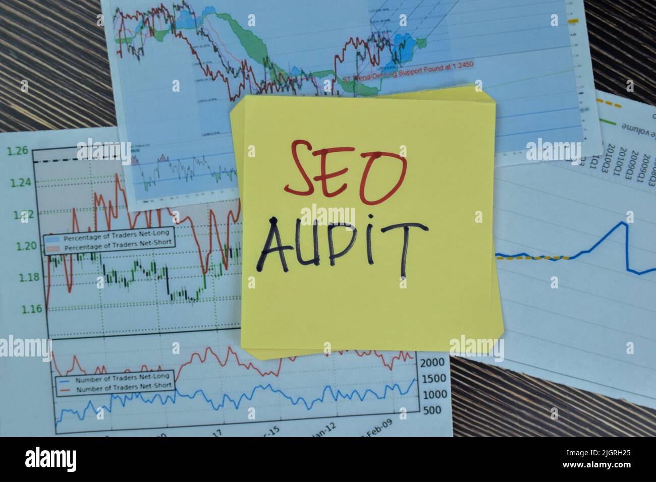 Concept of SEO Audit write on sticky notes isolated on Wooden Table. Stock Photo