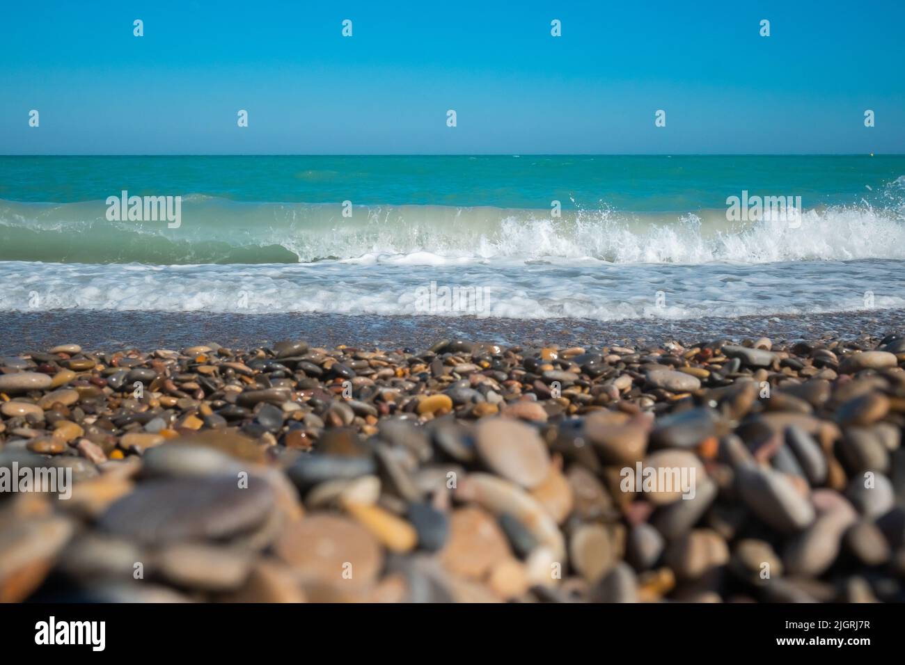 Mediterranean sea with waves with stony beach.  Stock Photo