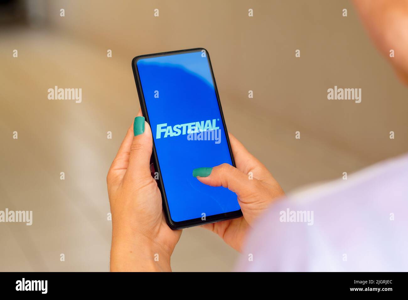 In this photo illustration, a woman holds a smartphone with the ...