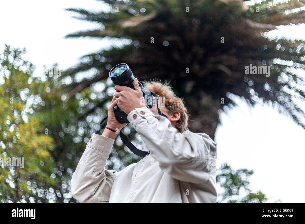 Blond traveler man taking a picture in the nature Stock Photo