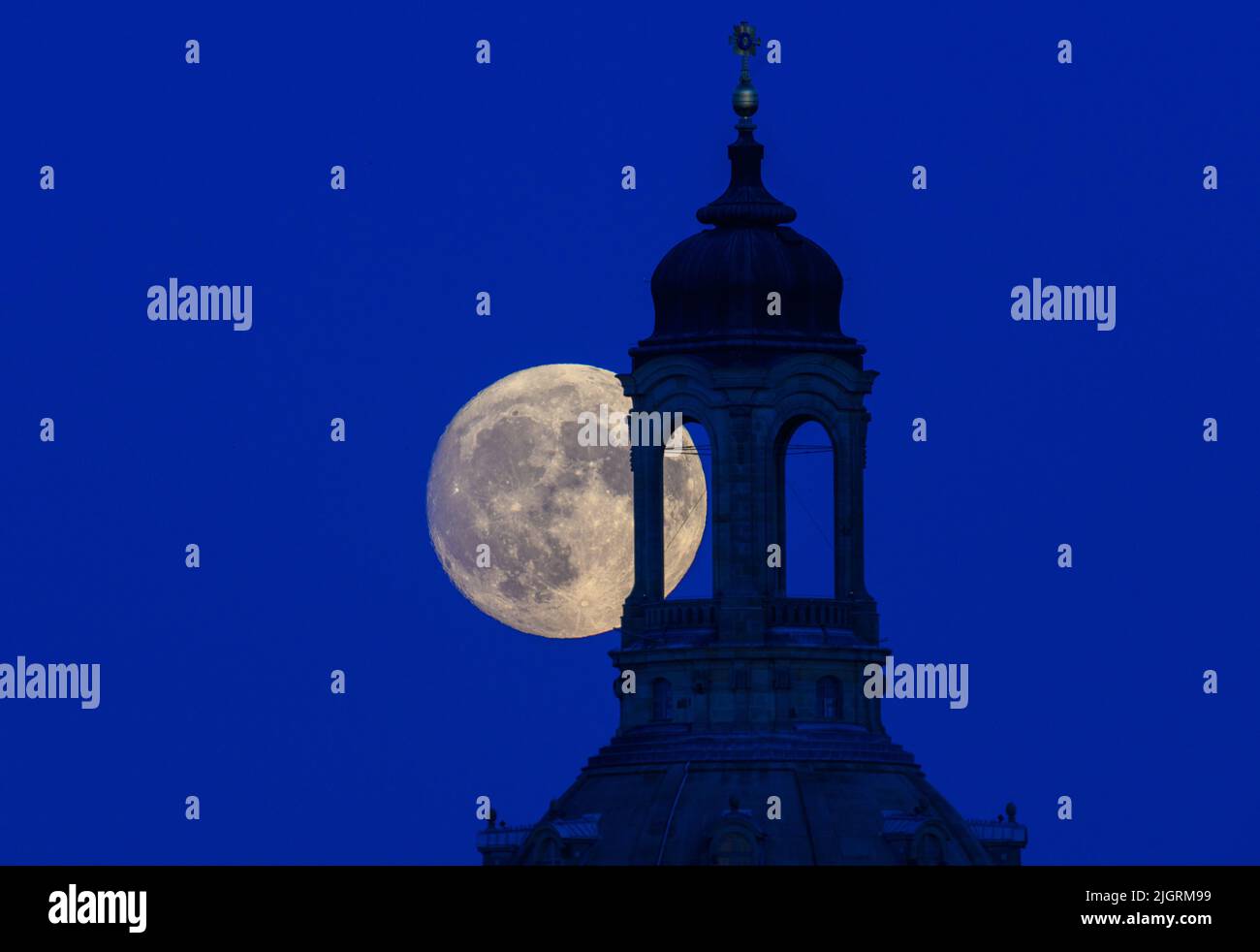 Dresden, Germany. 12th July, 2022. The waxing moon rises in the evening behind the Frauenkirche. On July 13, 2022, the moon will be full shortly after 8:30 pm. At the same time, the moon is close to the earth, which is why it is called a supermoon. Credit: Robert Michael/dpa/Alamy Live News Stock Photo