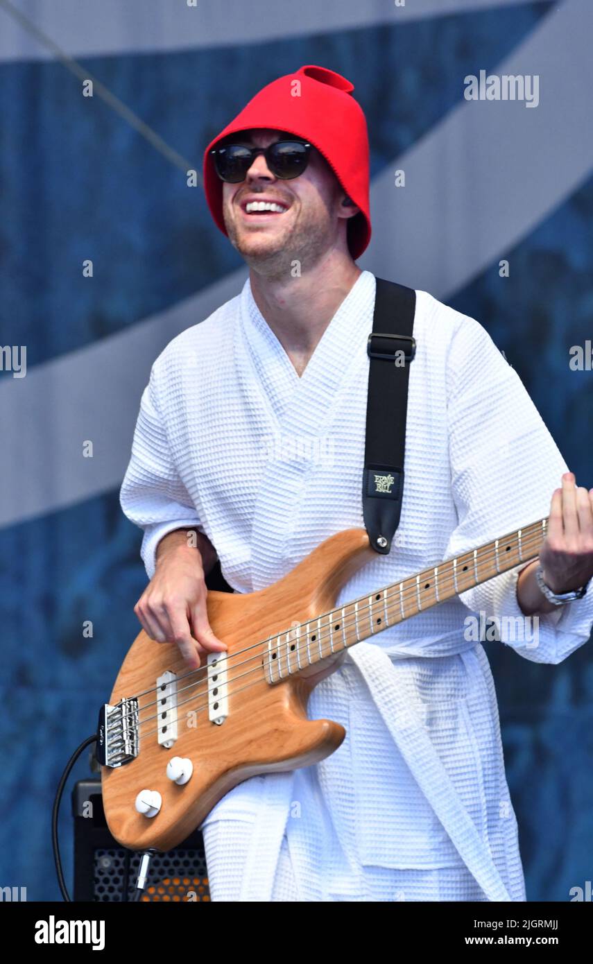 Vulfpeck band members are shown performing on stage during a “live