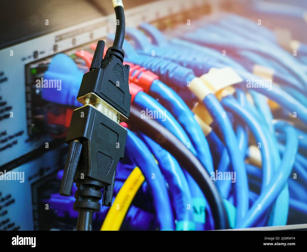 Both end of a VGA Cable (Male and Female) connected In front of a