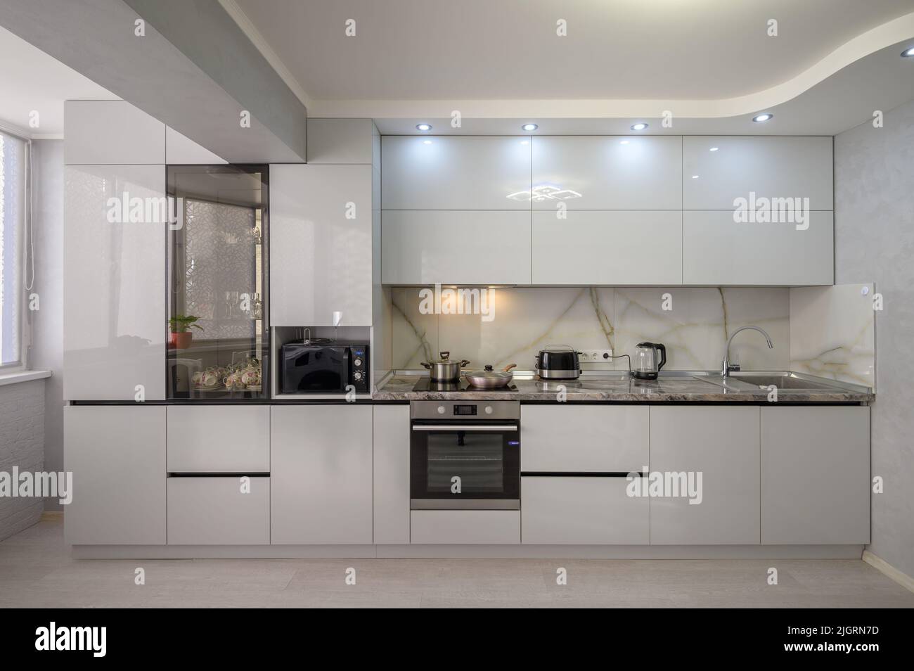 Interior of modern trendy white kitchen, front view Stock Photo - Alamy