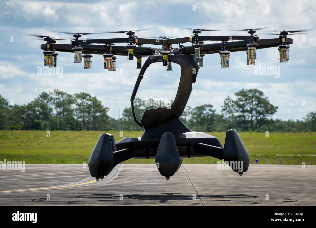 The Hexa, an electric, vertical takeoff and landing aircraft, lifts off during its first test flight at a military airfield July 7 at Eglin Air Force Base, Fla. The Hexa team completed the aircraft’s flight test via remote control. The aircraft, which used 18 motors and propellors, flew for approximately 10 minutes and reached a height of about 50 feet. (U.S. Air Force photo/Samuel King Jr.) Stock Photo