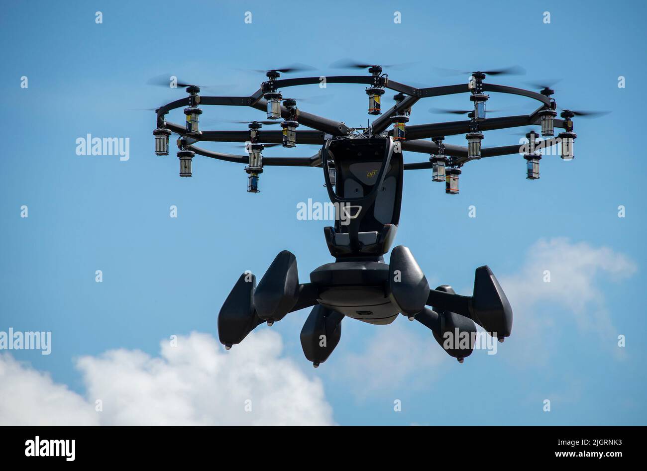 The Hexa, an electric, vertical takeoff and landing aircraft, hovers in the air during its first test flight at a military airfield July 7 at Eglin Air Force Base, Fla. The Hexa team completed the aircraft’s flight test via remote control. The aircraft, which used 18 motors and propellors, flew for approximately 10 minutes and reached a height of about 50 feet. (U.S. Air Force photo/Samuel King Jr.) Stock Photo