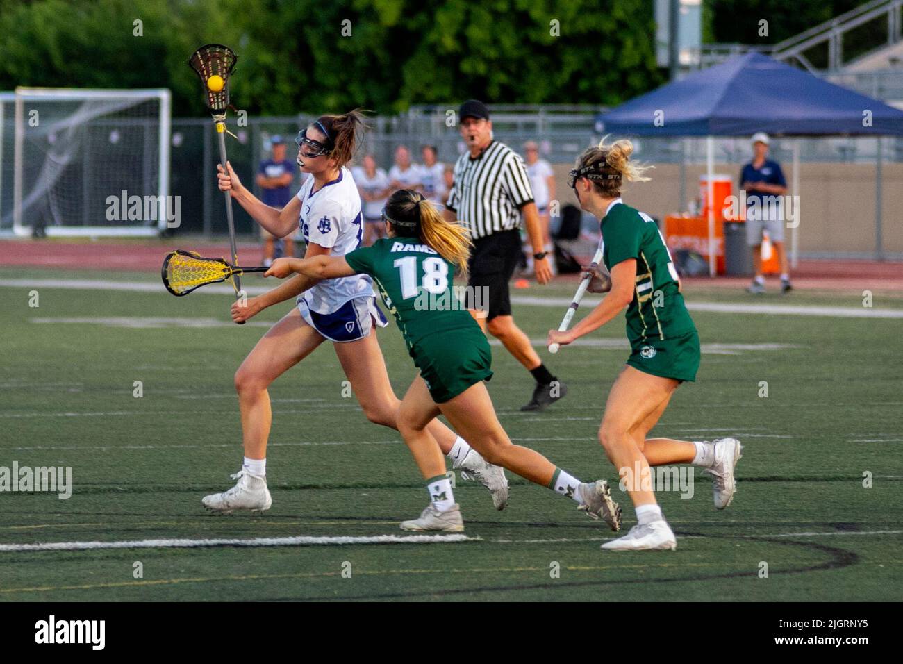 High school girls play a spirited lacrosse game in a Downey, CA