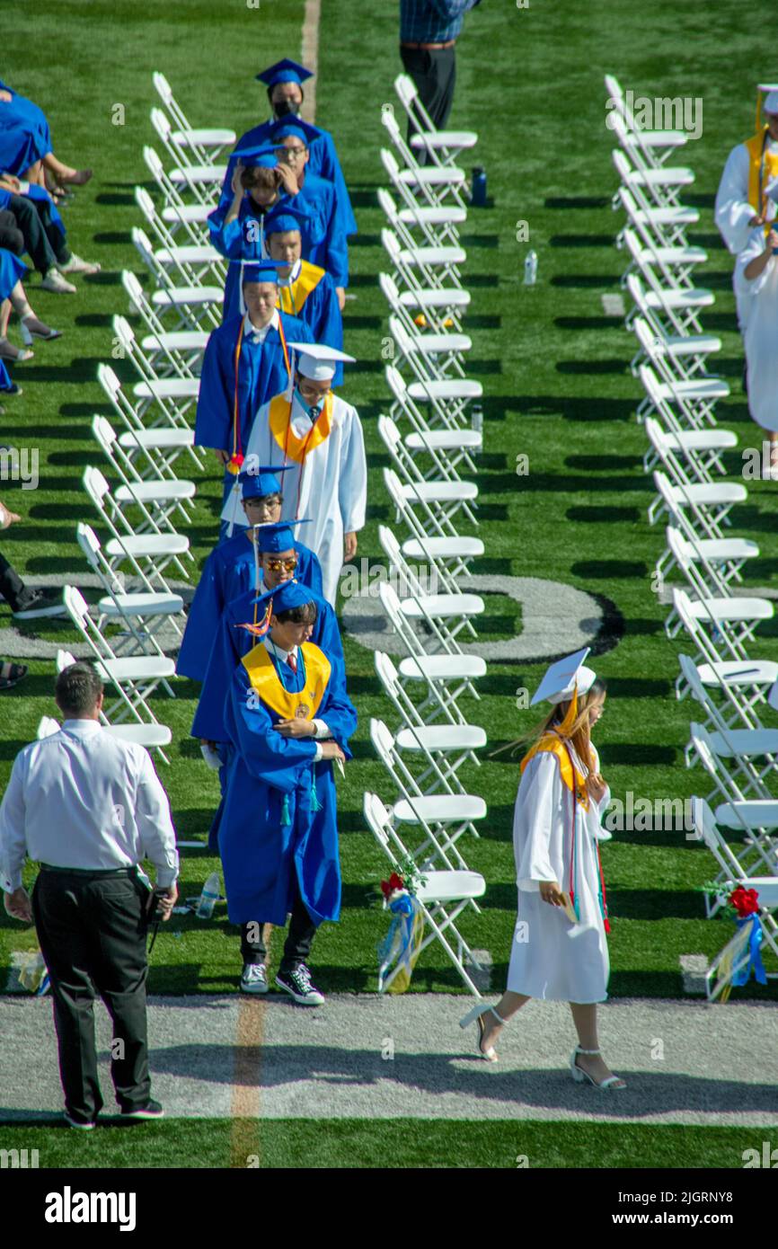 Wearing their ceremonial caps and gowns, multiracial high school