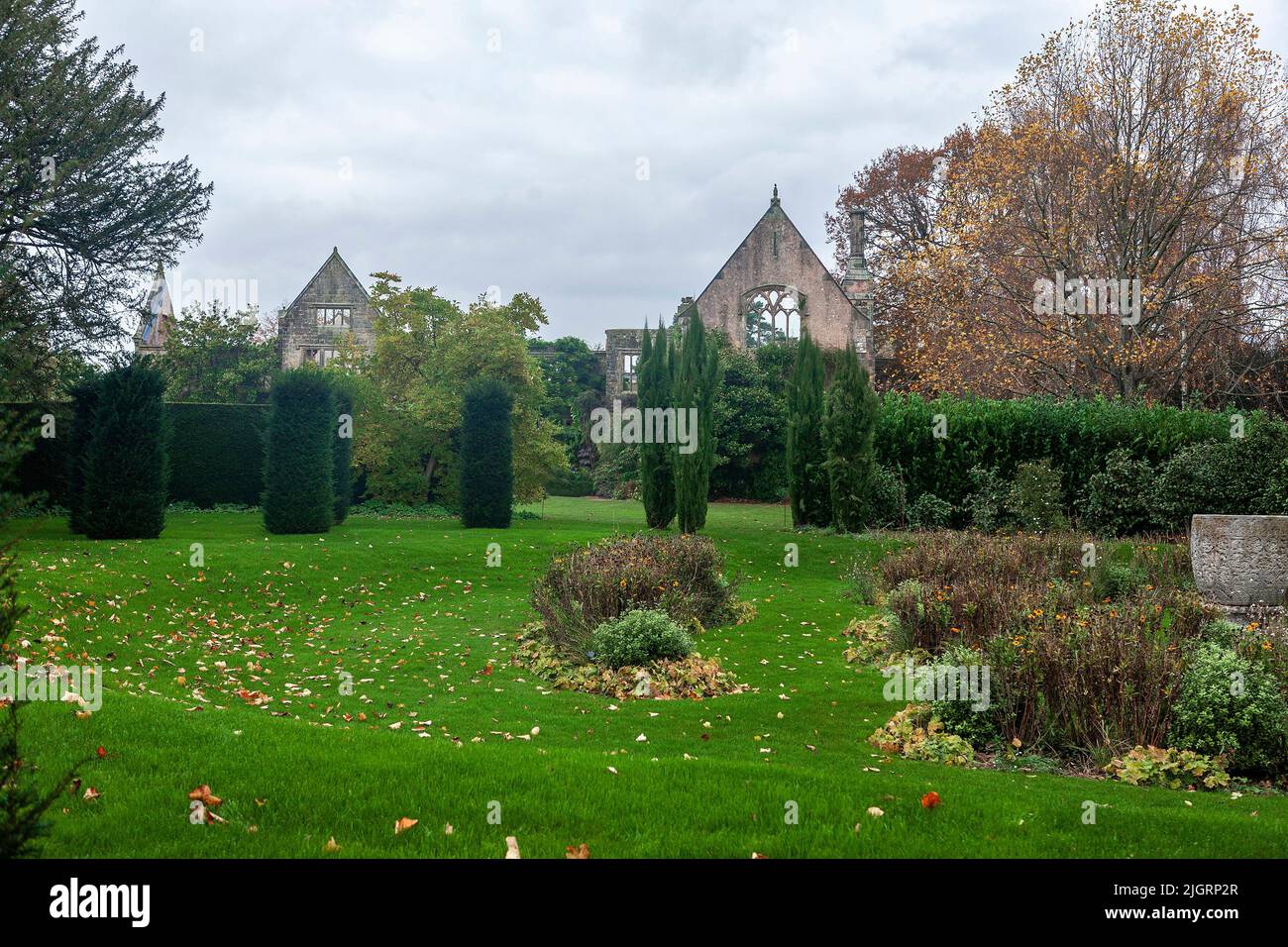 Nymans, West Sussex, UK: sunken garden and ruins of the house, damaged by fire in 1947, and left as a romantic monument Stock Photo