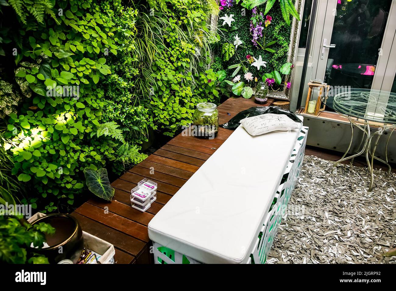 A beautiful rooftop seating area surrounded by a garden Stock Photo