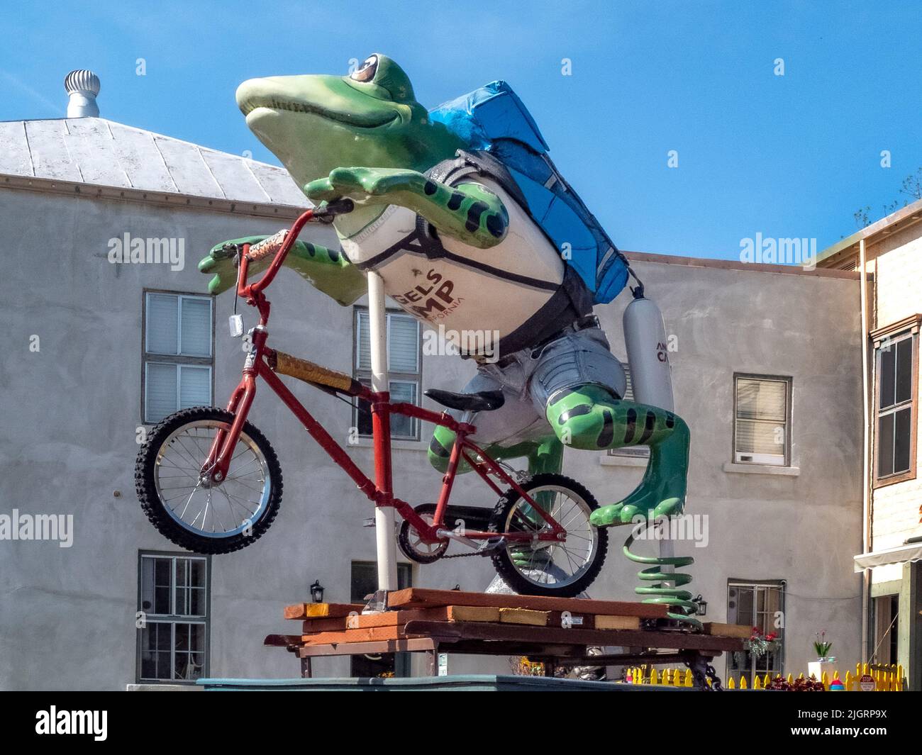 A humorous model of a bicycle mounted jumping frog decorates the main