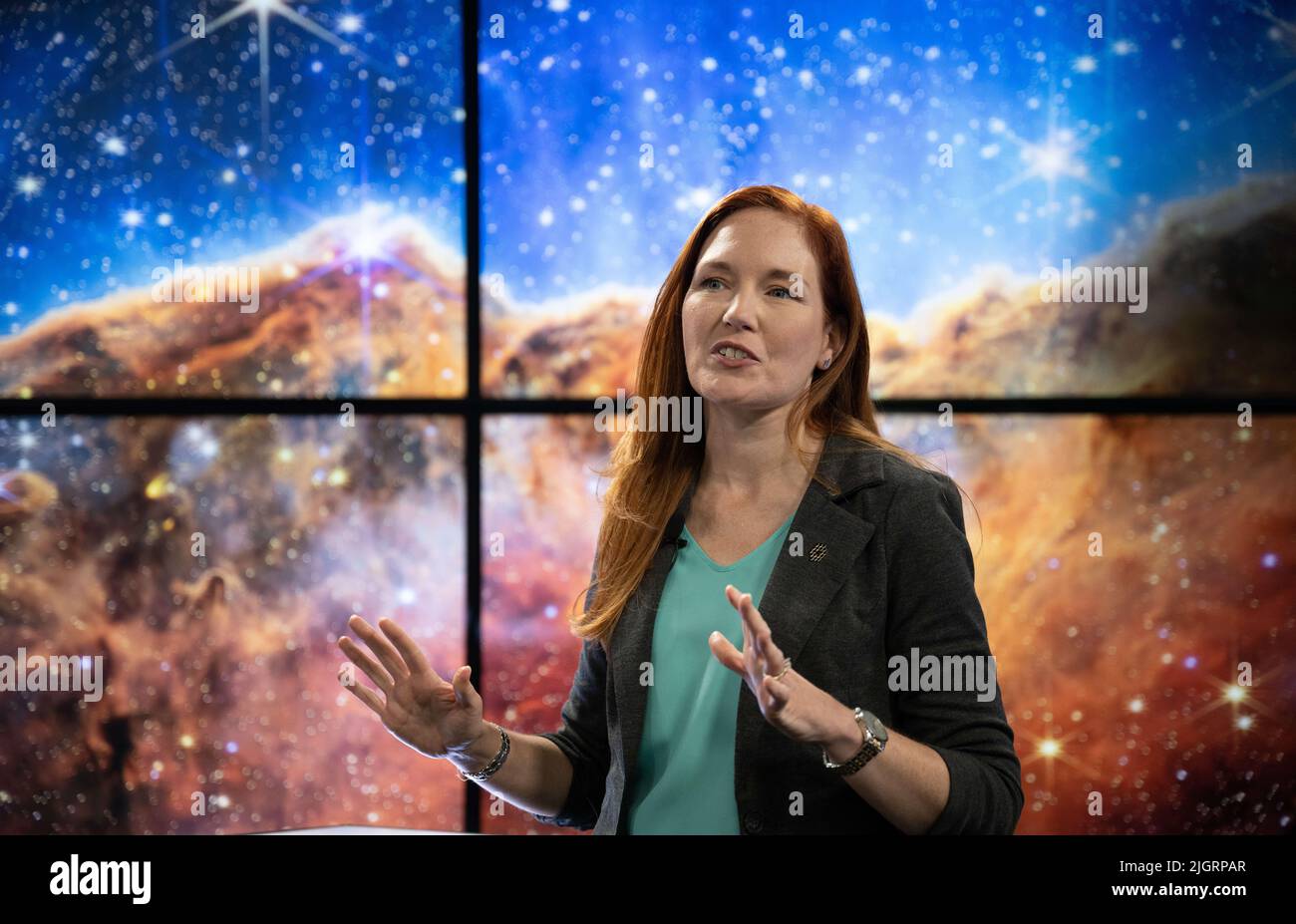 (220712) -- GREENBELT (U.S.), July 12, 2022 (Xinhua) -- NASA James Webb Space Telescope Deputy Project Scientist for Communications Amber Straughn speaks about the infrared image of the star-forming region called NGC 3324 in the Carina Nebula as it is shown on a screen during a broadcast releasing the telescope's first full-color images at NASA's Goddard Space Flight Center in Greenbelt, Maryland, the Untied States, on July 12, 2022. NASA released James Webb Space Telescope's first full-color images of the universe and their spectroscopic data on Tuesday, revealing the unprecedented and detail Stock Photo