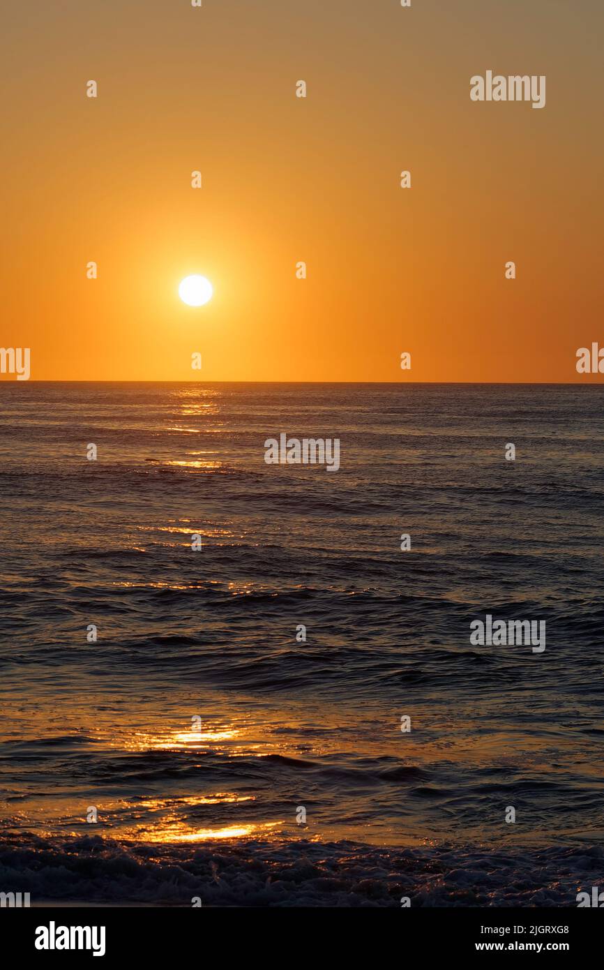 Golden sunrise viewed from the beach at Rehoboth Beach, Delaware USA. Stock Photo