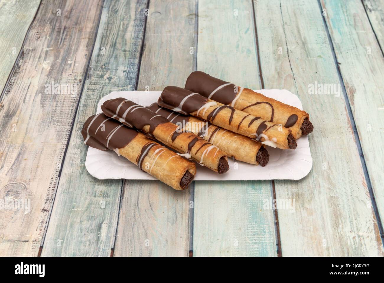 Chocolate flutes dessert, with chocolate filling and melted chocolate