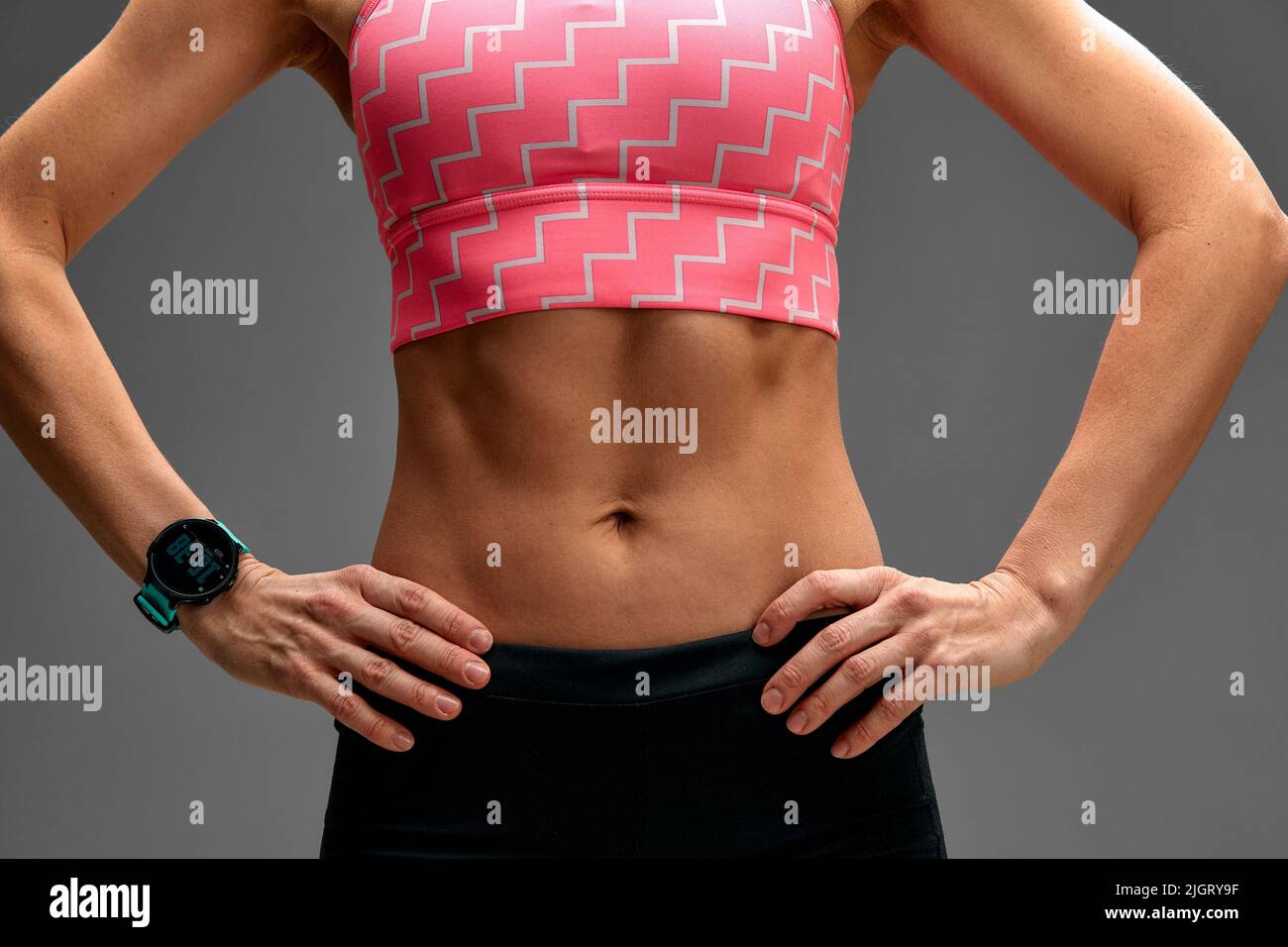 Free Photo  Cropped close up body of fit woman wearing shorts and sport  top showing slim beautiful stomach and abs