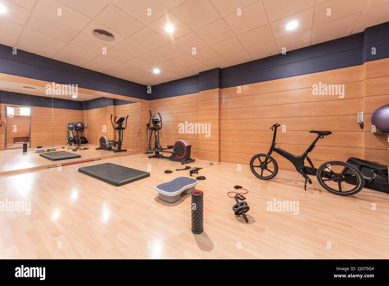 A gym room with stationary bikes, steps and objects to perform various exercises Stock Photo