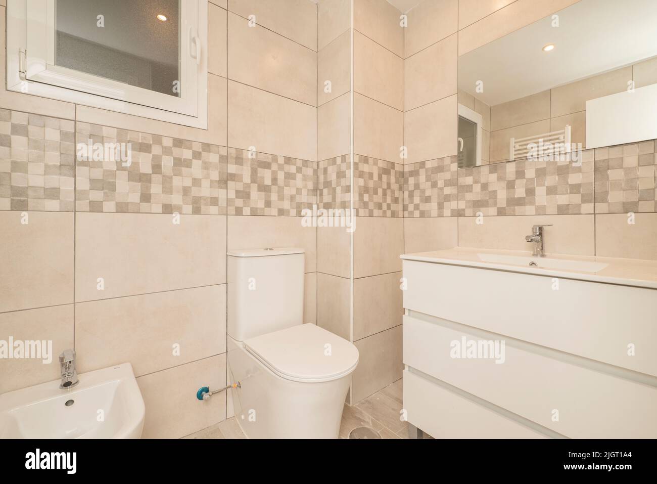 Small modern bathroom with frameless mirror on the wall, white ...