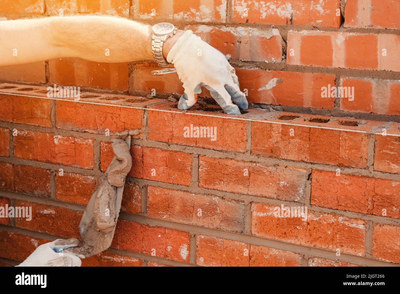 Bricklayers laying bricks on mortar Stock Photo Alamy