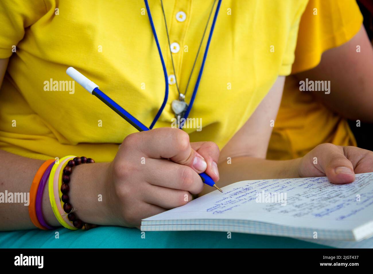 girl writes information in a notebook Stock Photo