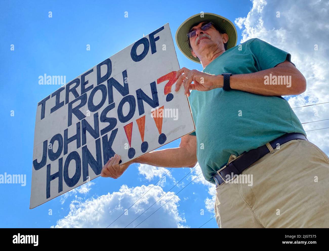 Racine, Wisconsin, USA. 12th July, 2022. Former Wisconsin State Senator JOHN LEHMAN is one of eleven people participating in their weekly protest against Sen. Ron Johnson (R-Wisconsin) at a busy intersection outside Racine, Wisconsin Tuesday July 12, 2022. They started the protests two months ago, and plan to continue until the November election. Johnson's Democratic opponent will be determined in an August primary election. The protesters also had signs about gun control and abortion rights. They had previously protested weekly in downtown Racine for the length of Donald J. Trump's presiden Stock Photo