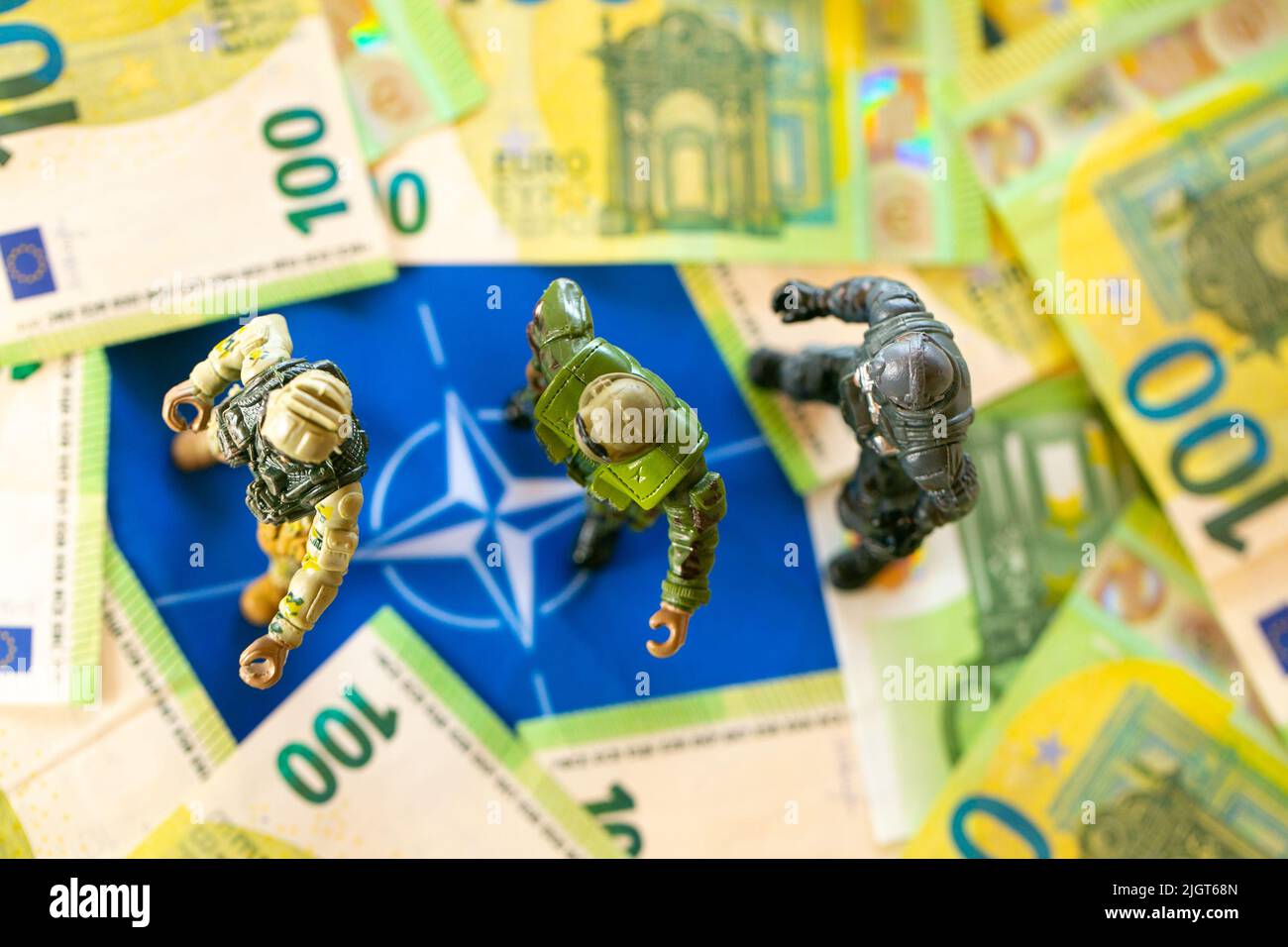 Military spending.Financing the supply of weapons, the army in Europe.Money for armaments and troops. firearms decorative and bills on the flag of the Stock Photo