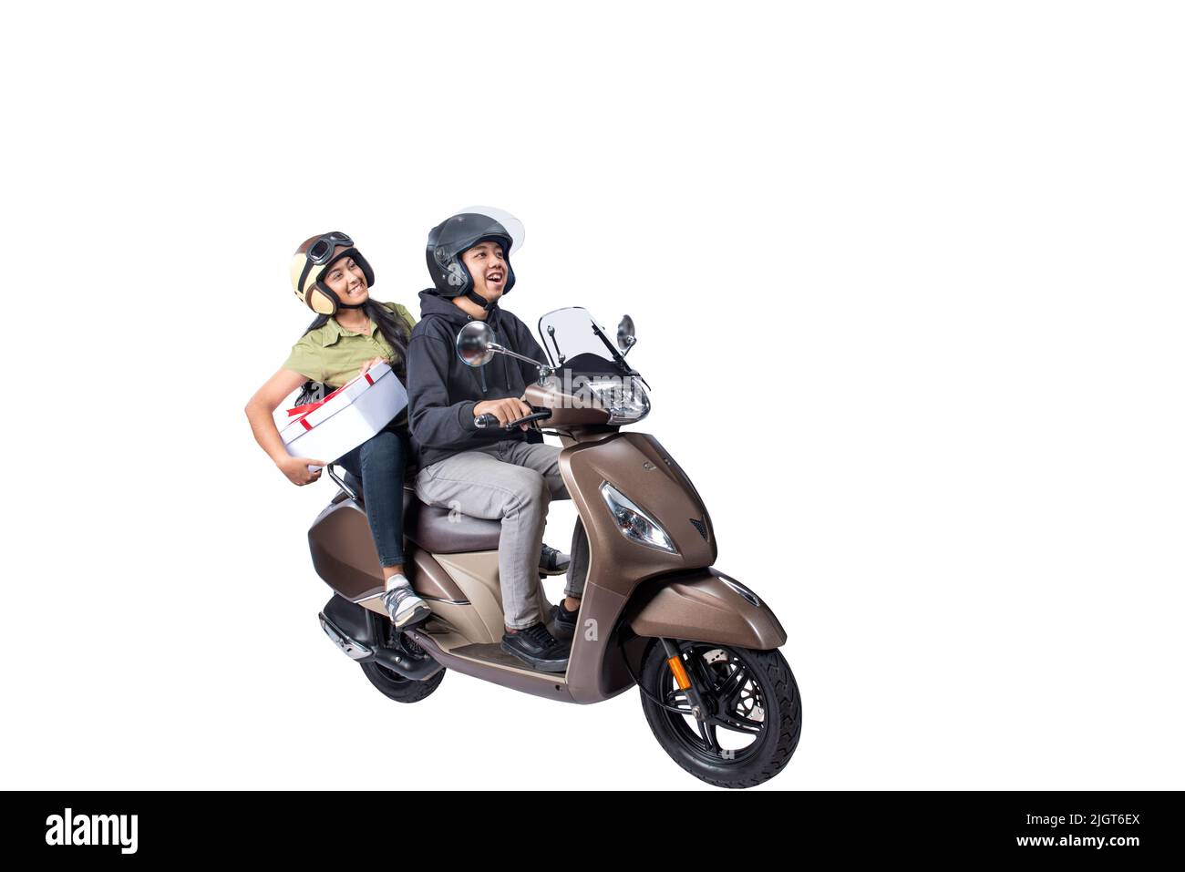Asian couple with a helmet sitting on a scooter and carrying a gift box isolated over white background Stock Photo