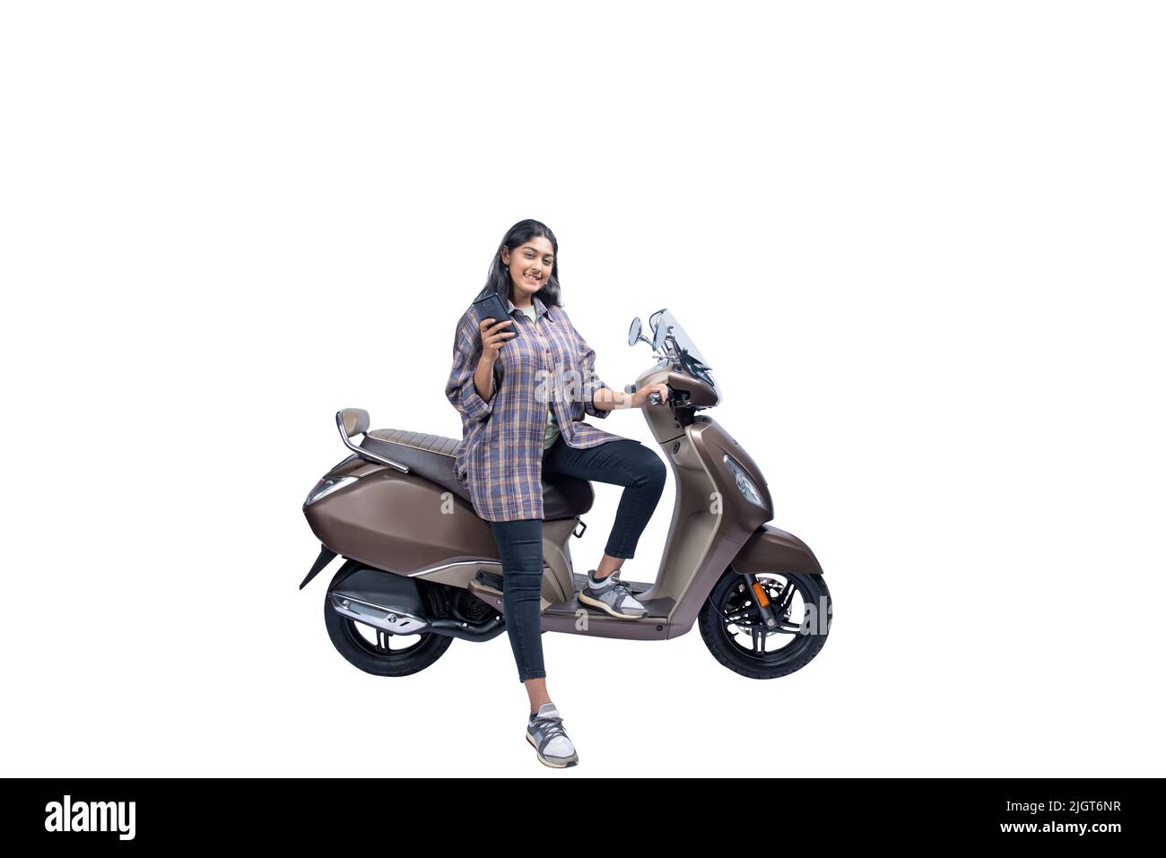 Asian woman sitting on a scooter while using a mobile phone isolated over white background Stock Photo