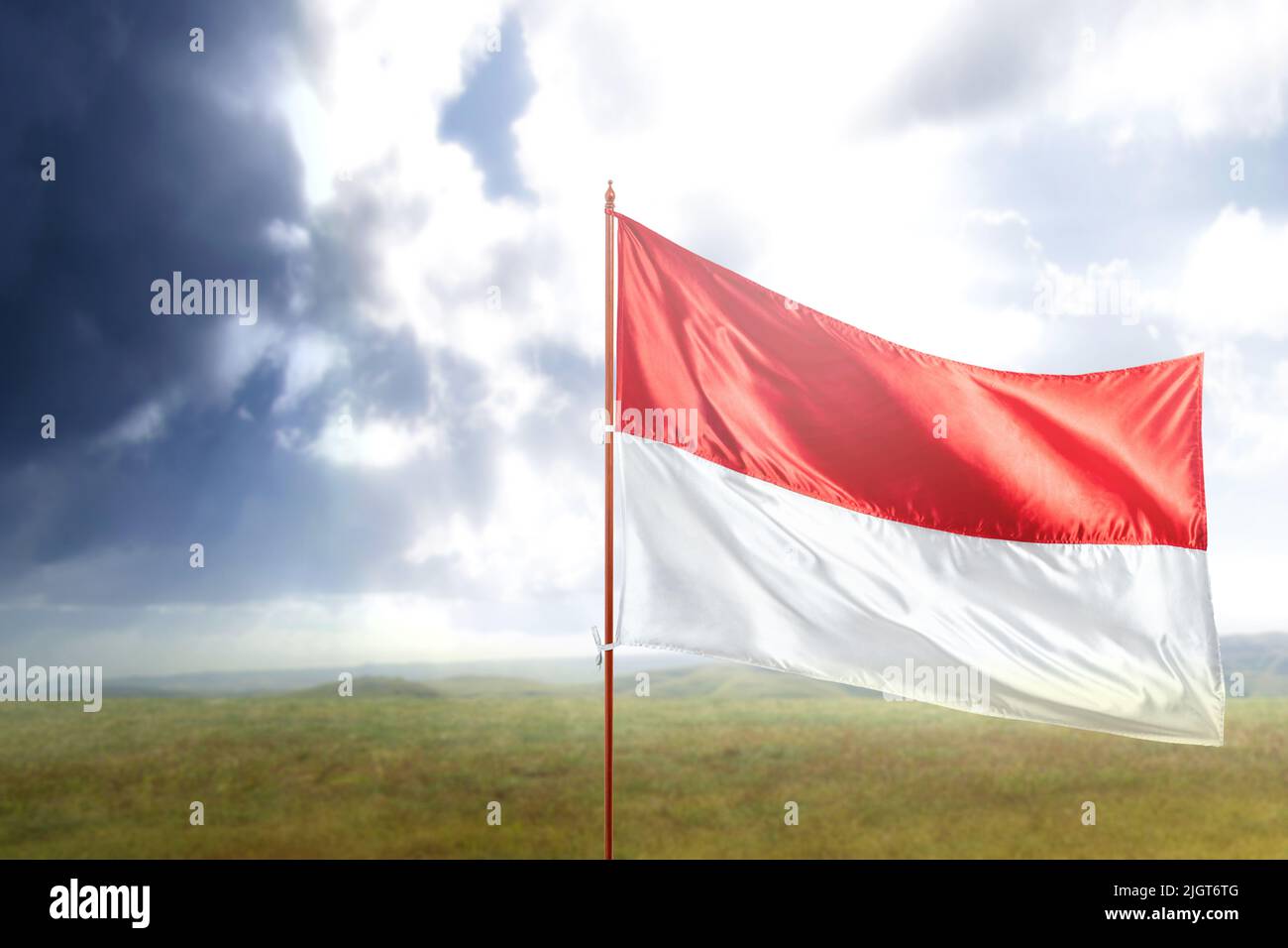 Indonesian flag on the pole waving with blue sky background Stock Photo ...