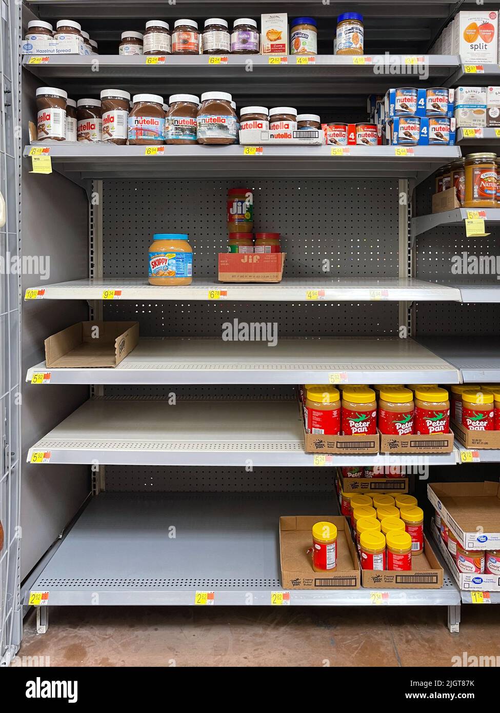 Empty peanut butter shelves at grocery store. Supply chain disruption.  Stock Photo