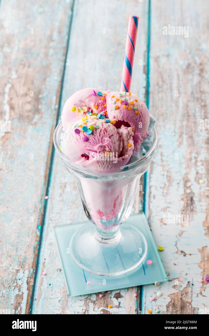 A cotton candy ice cream sundae topped with sprinkles, ready for eating Stock Photo Alamy