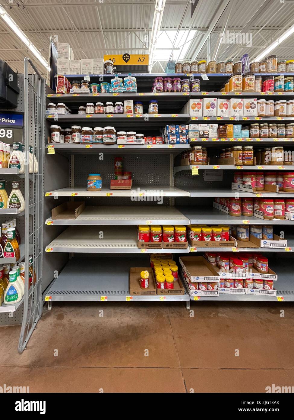 Empty peanut butter shelves at grocery store. Supply chain disruption.  Stock Photo
