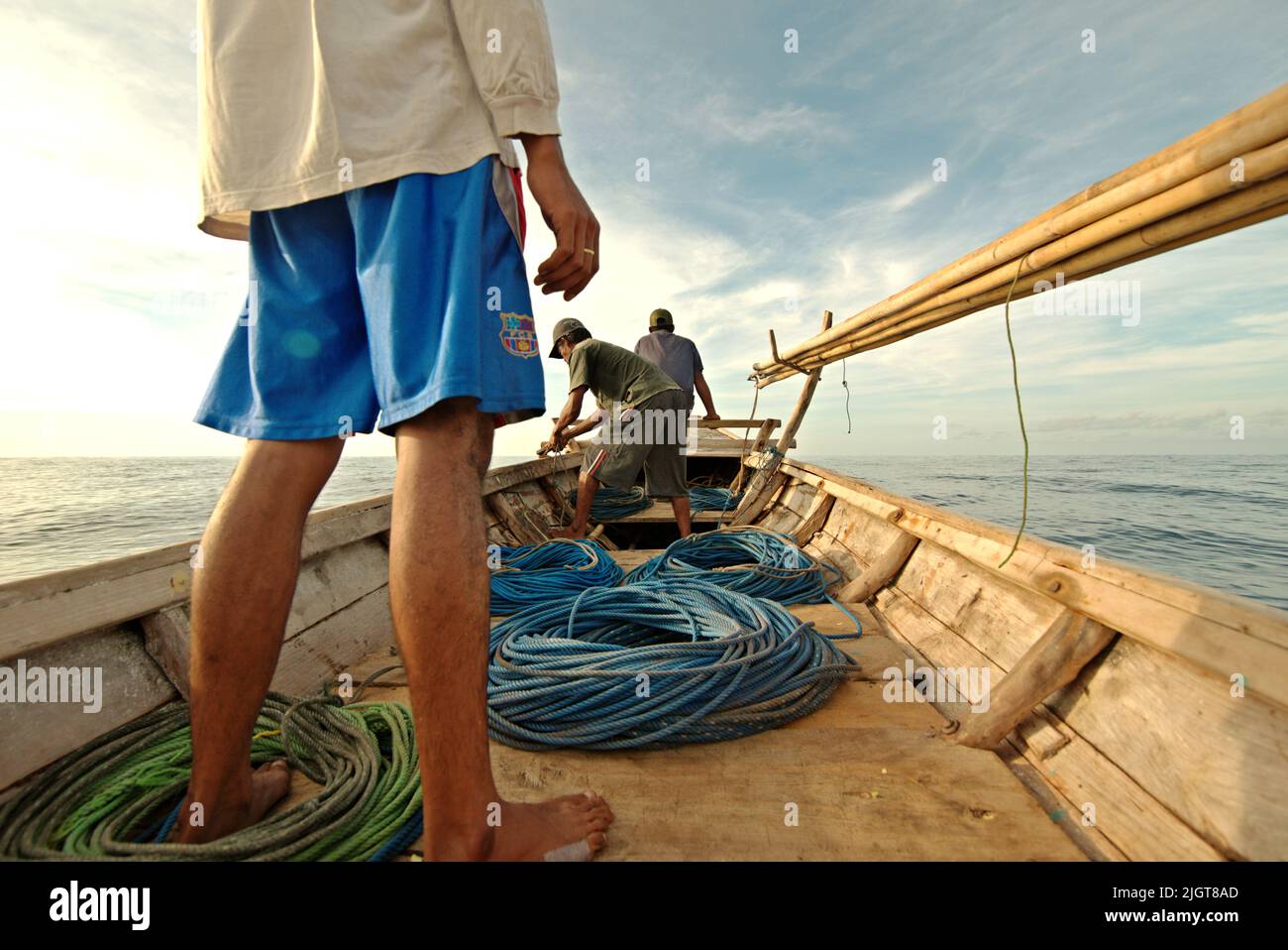 Whale hunters on traditional whaling boat equipped with bamboo harpoons ...