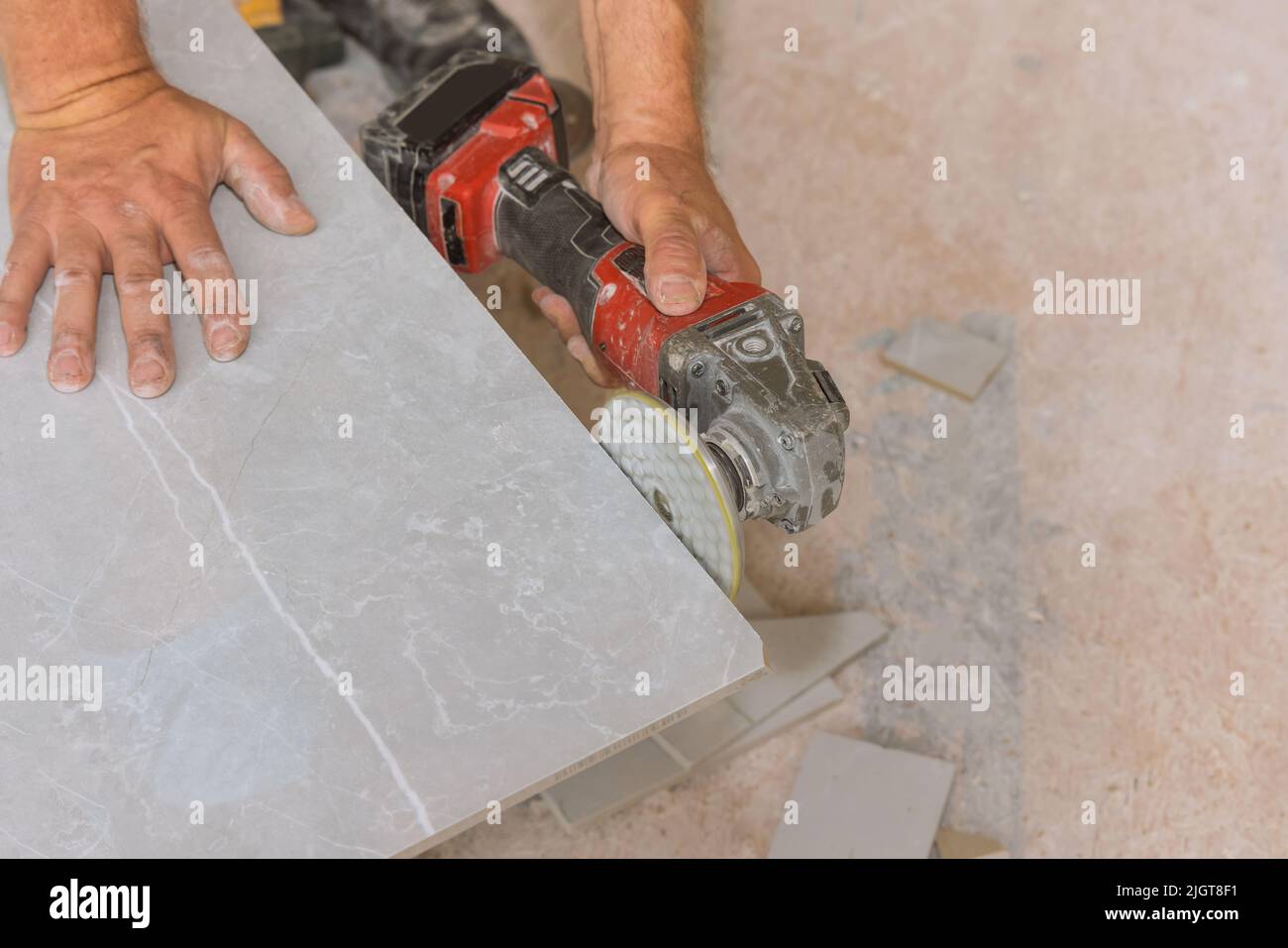 Angle grinder polishing disk with diamond is used by the worker for