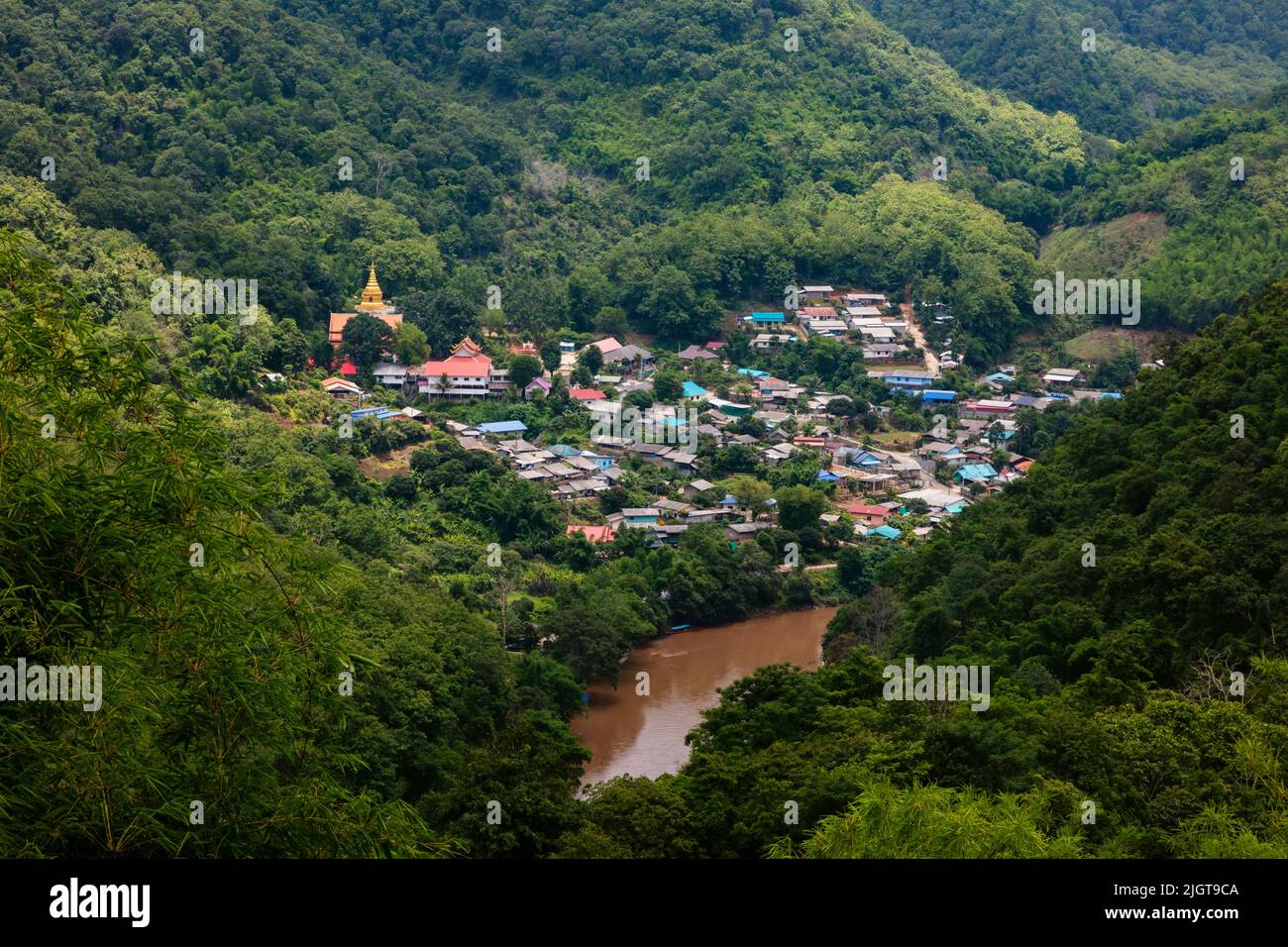 A Burmese village across the Mae Kok River near the town of Tha Thong in Northern Thailand Stock Photo