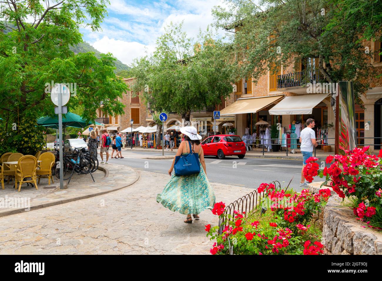 One of the many picturesque tree lined streets of shops and cafes in the hilltop village of Valldemossa, Spain, on the island of Mallorca, Spain. Stock Photo