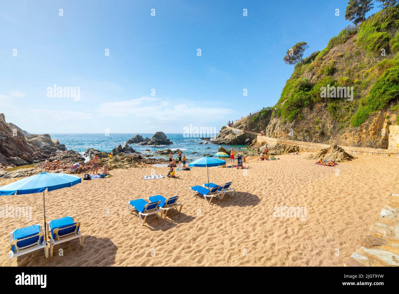 The sandy beach along the Costa Brava coast of the Mediterranean Sea at the resort town of Lloret de Mar, Spain. Stock Photo