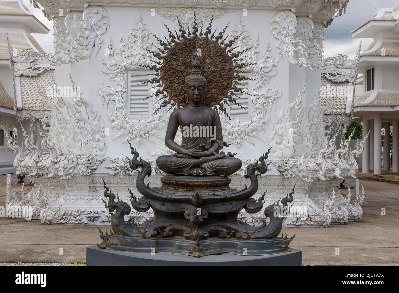 Buddha statue at the modern Wat Rong Khun or  WHITE TEMPLE built by the artist Chalermachai Kositpipat  - CHIANG RAI, THAILAND Stock Photo