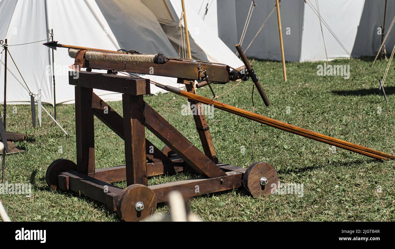 A closeup of a medieval catapult in a field on a sunny day Stock Photo