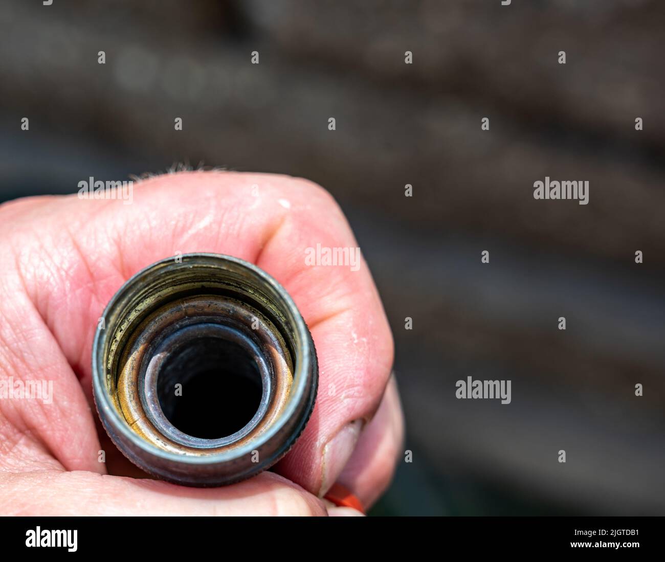 Looking into a garden hose that is missing the rubber gasket for sealing connections Stock Photo