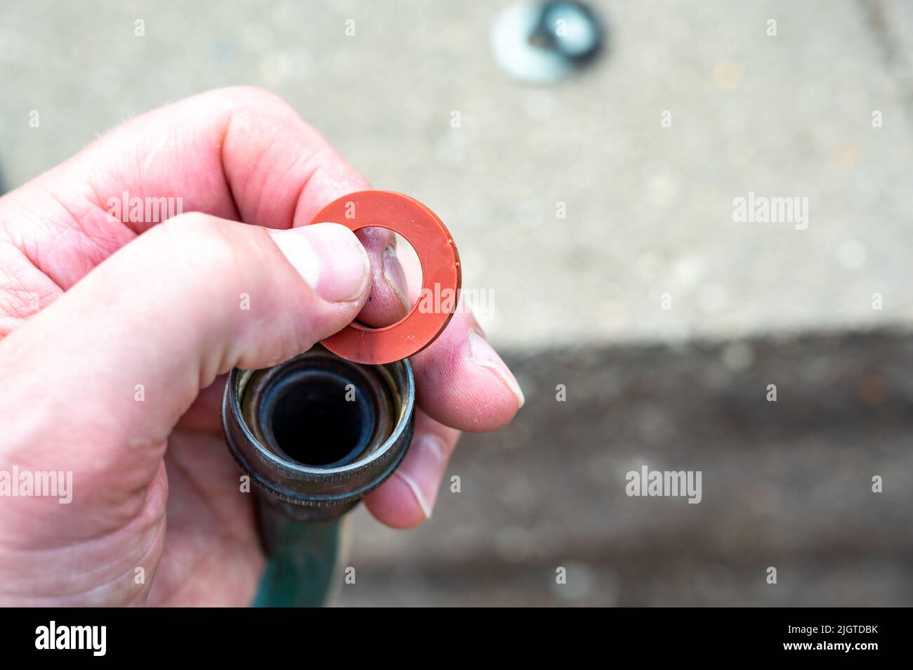 New rubber gasket being replaced in a garden hose female connection to