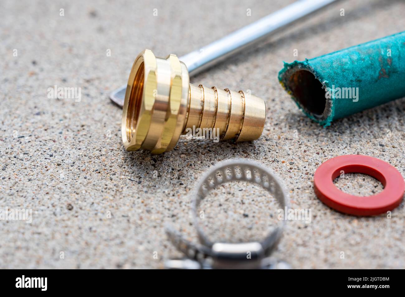 new garden hose replacement connection and pipe mender to tighten and secure repair. Stock Photo