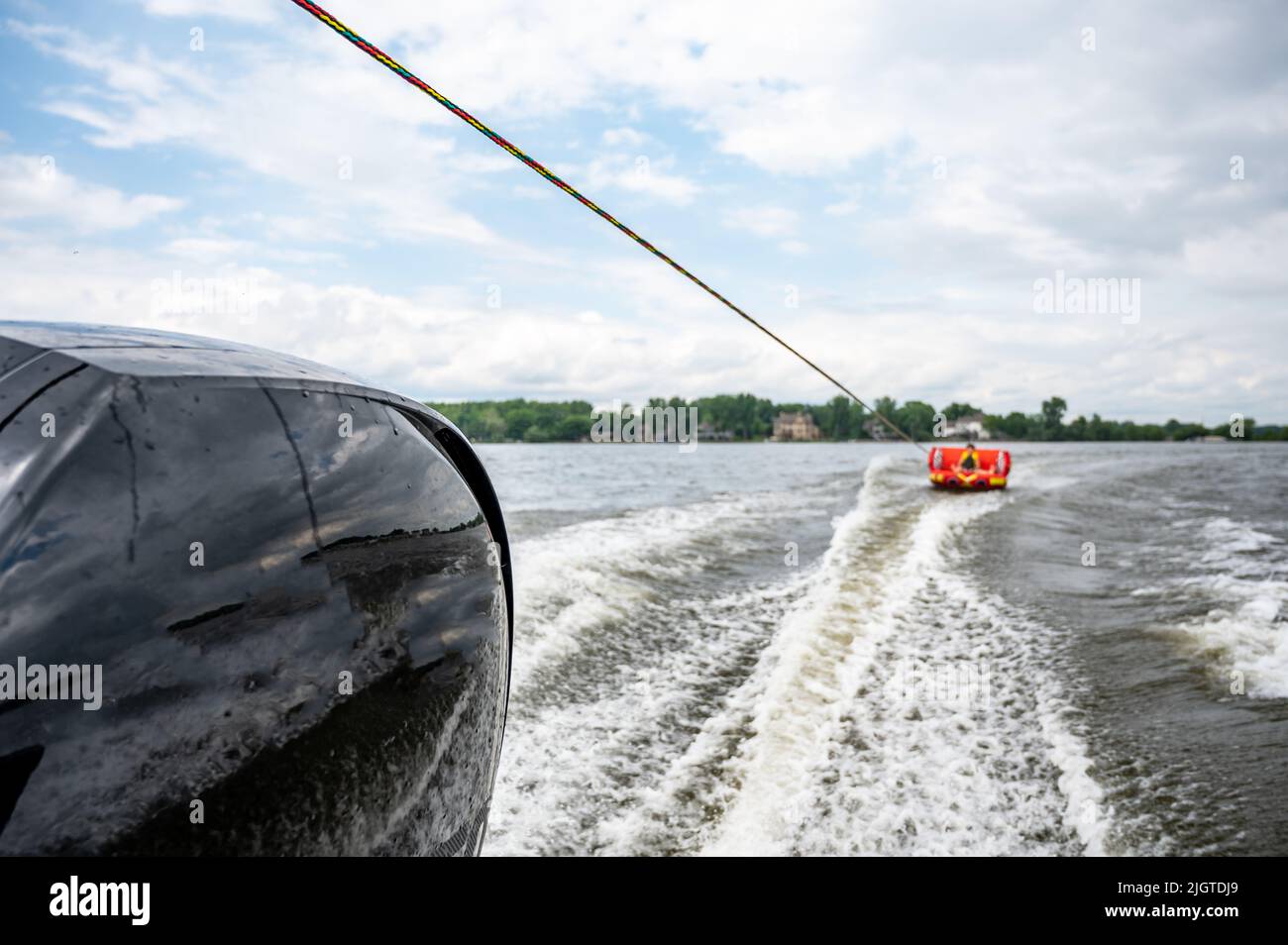 Inflatable raft being pulled at a high speed by a boat in a