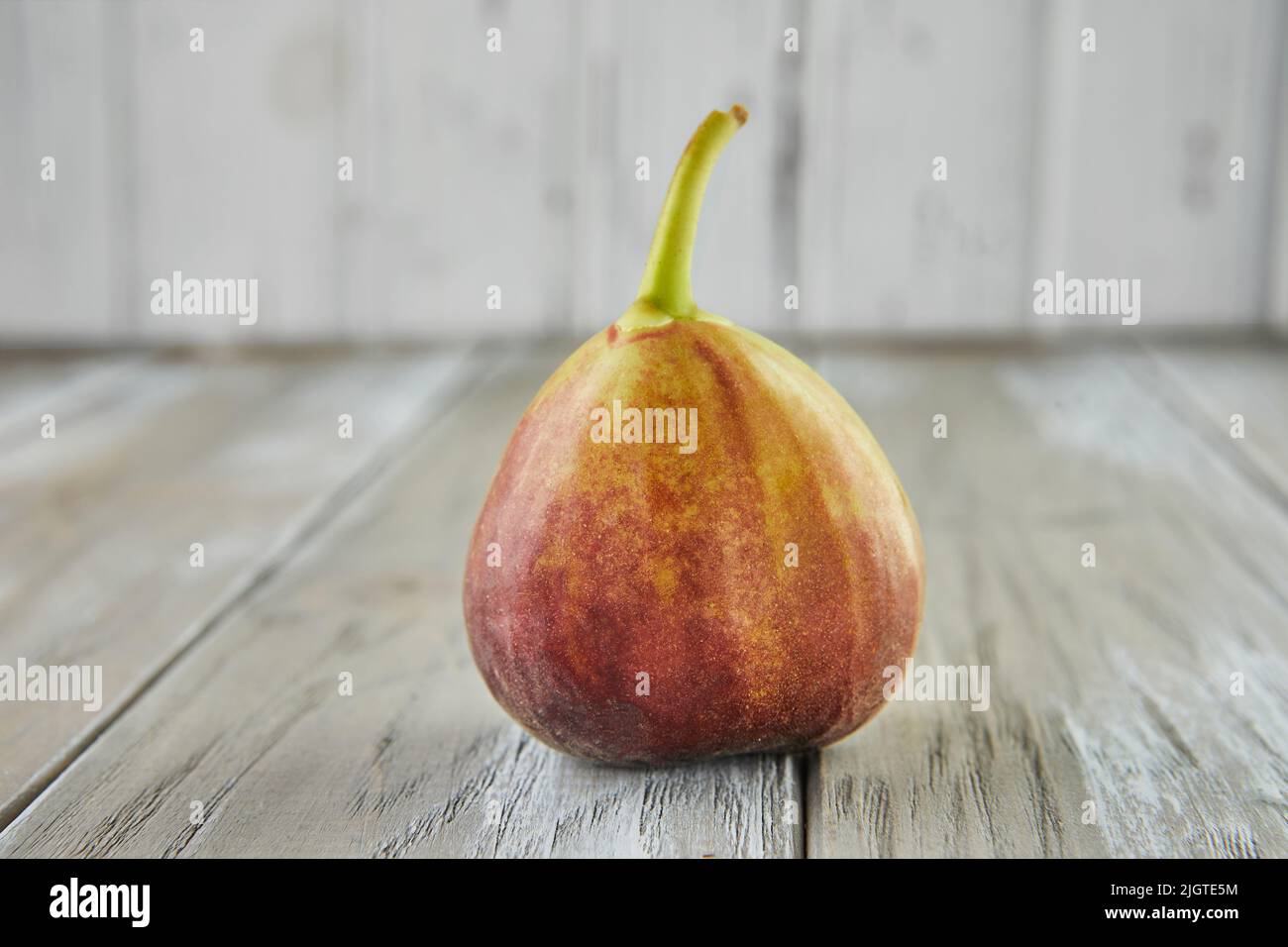 Fresh figs alone on wooden background, selective focus Stock Photo