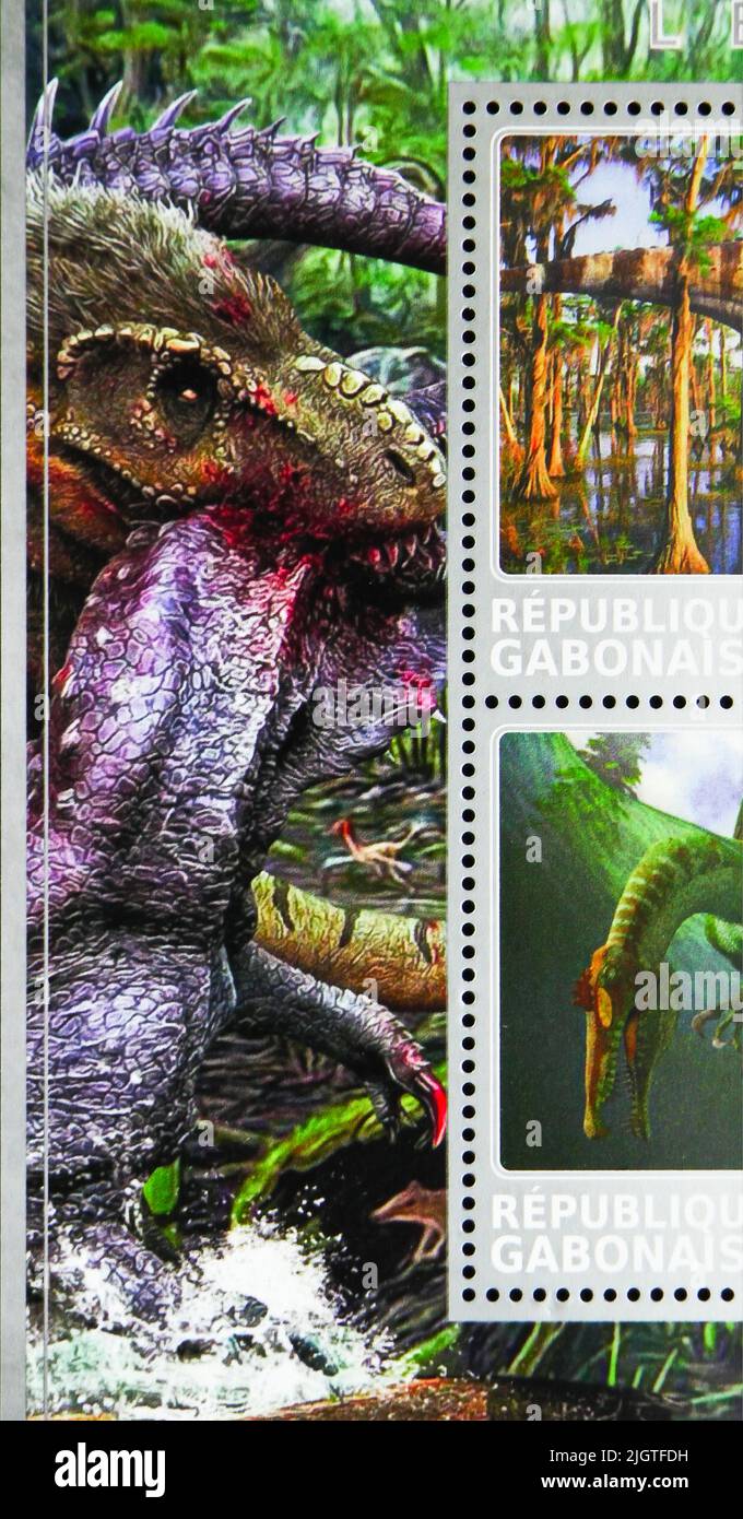 MOSCOW, RUSSIA - JUNE 17, 2022: Postage stamp printed in Gabon shows Reptile head bite neck, Dinosaurs serie, circa 2017 Stock Photo