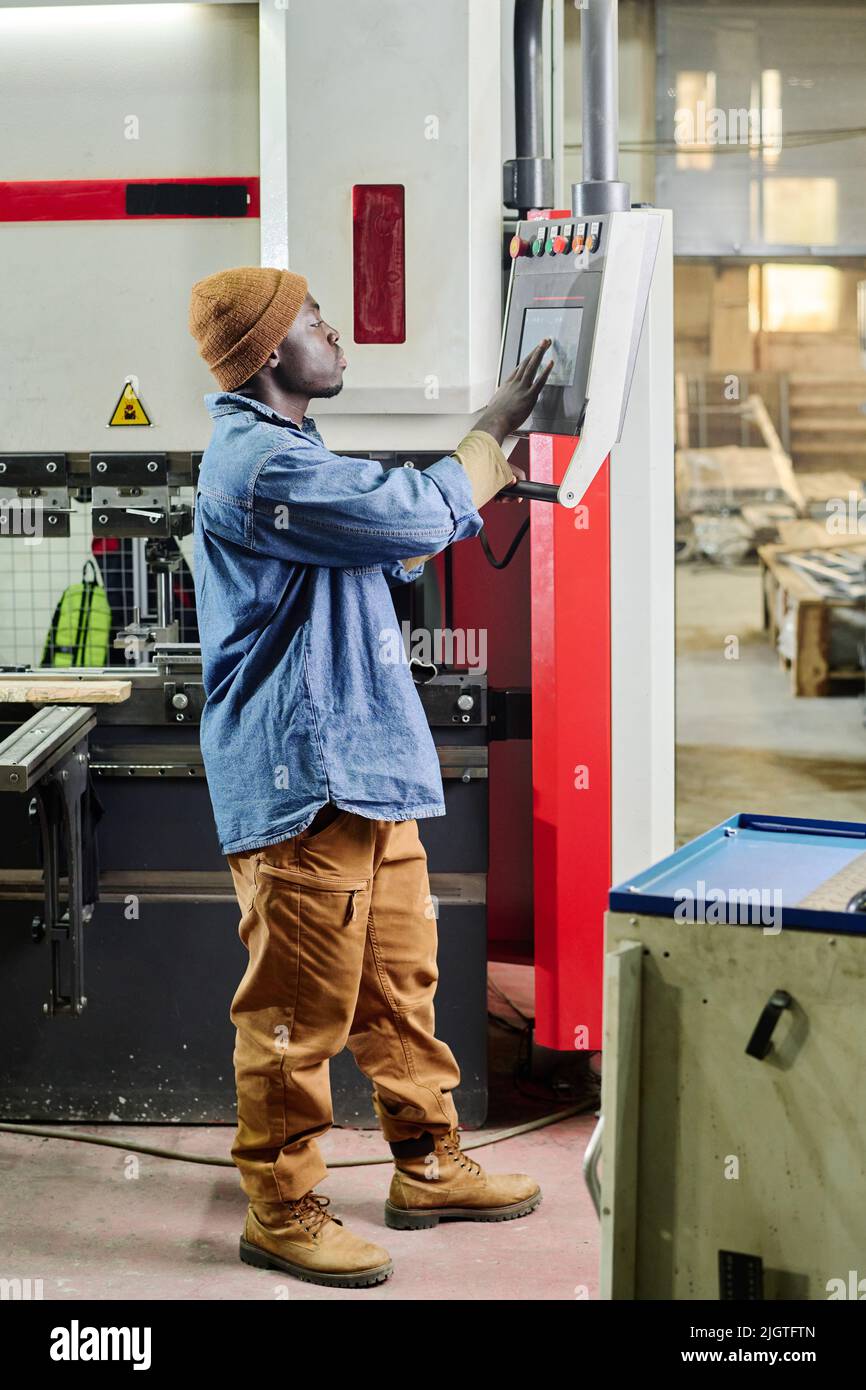 African young worker touching the monitor of computer machine to choose