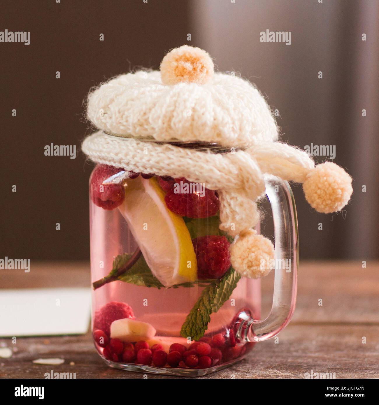 Natural tea with knitted cover closeup Stock Photo
