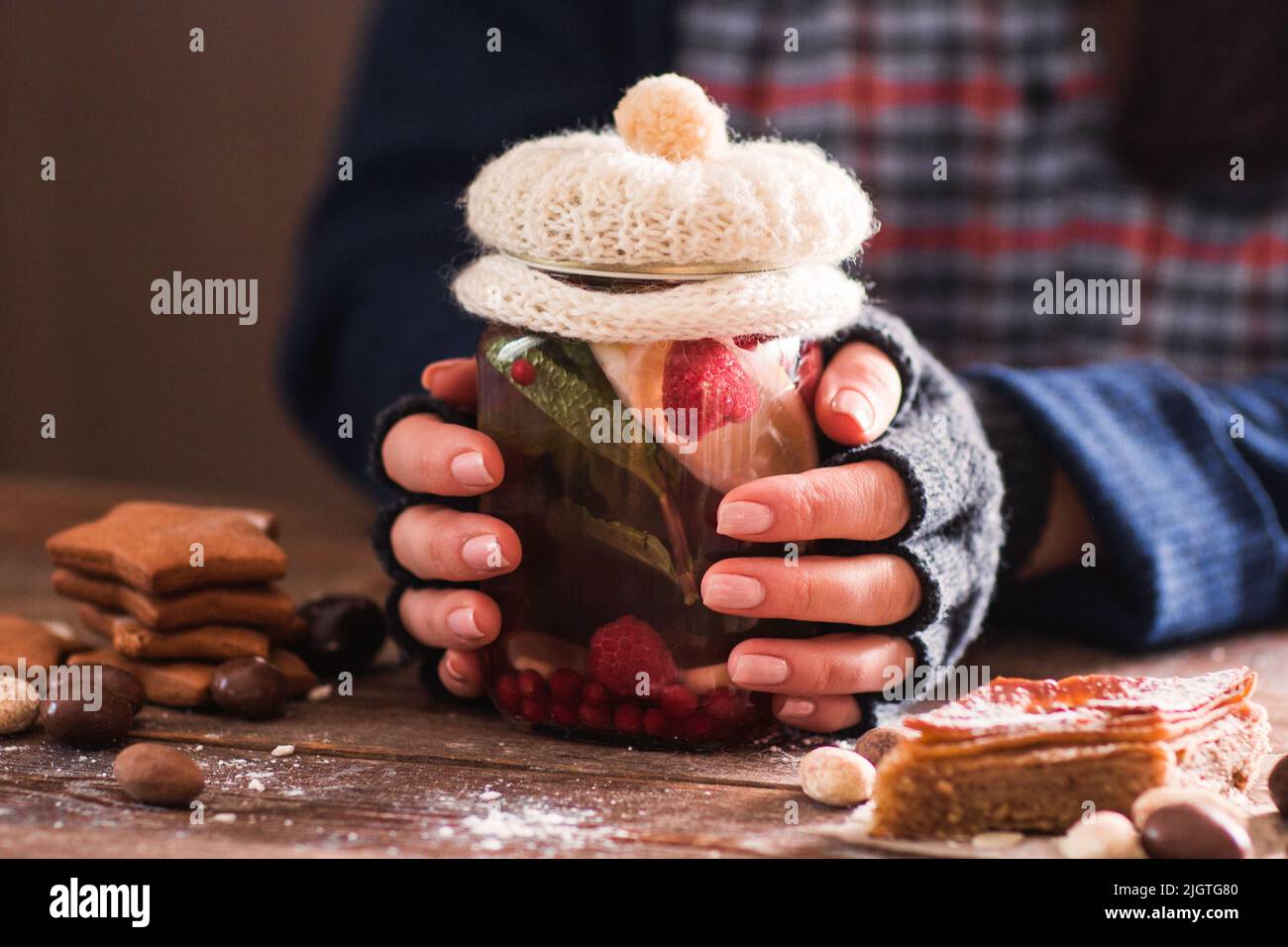 Frozen woman warm her hands with hot tea Stock Photo