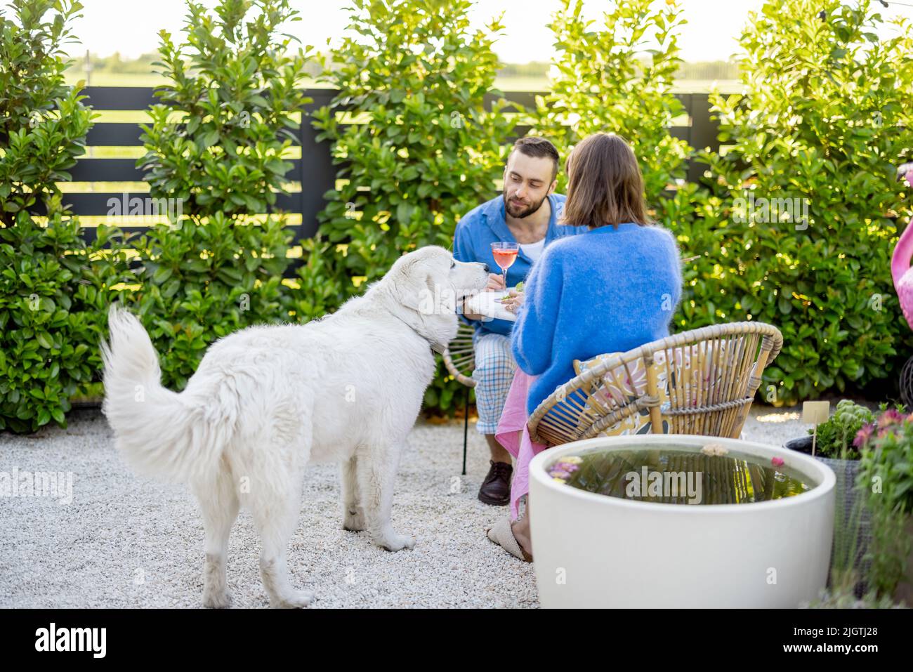 Young family relaxing at backyard during summer time Stock Photo