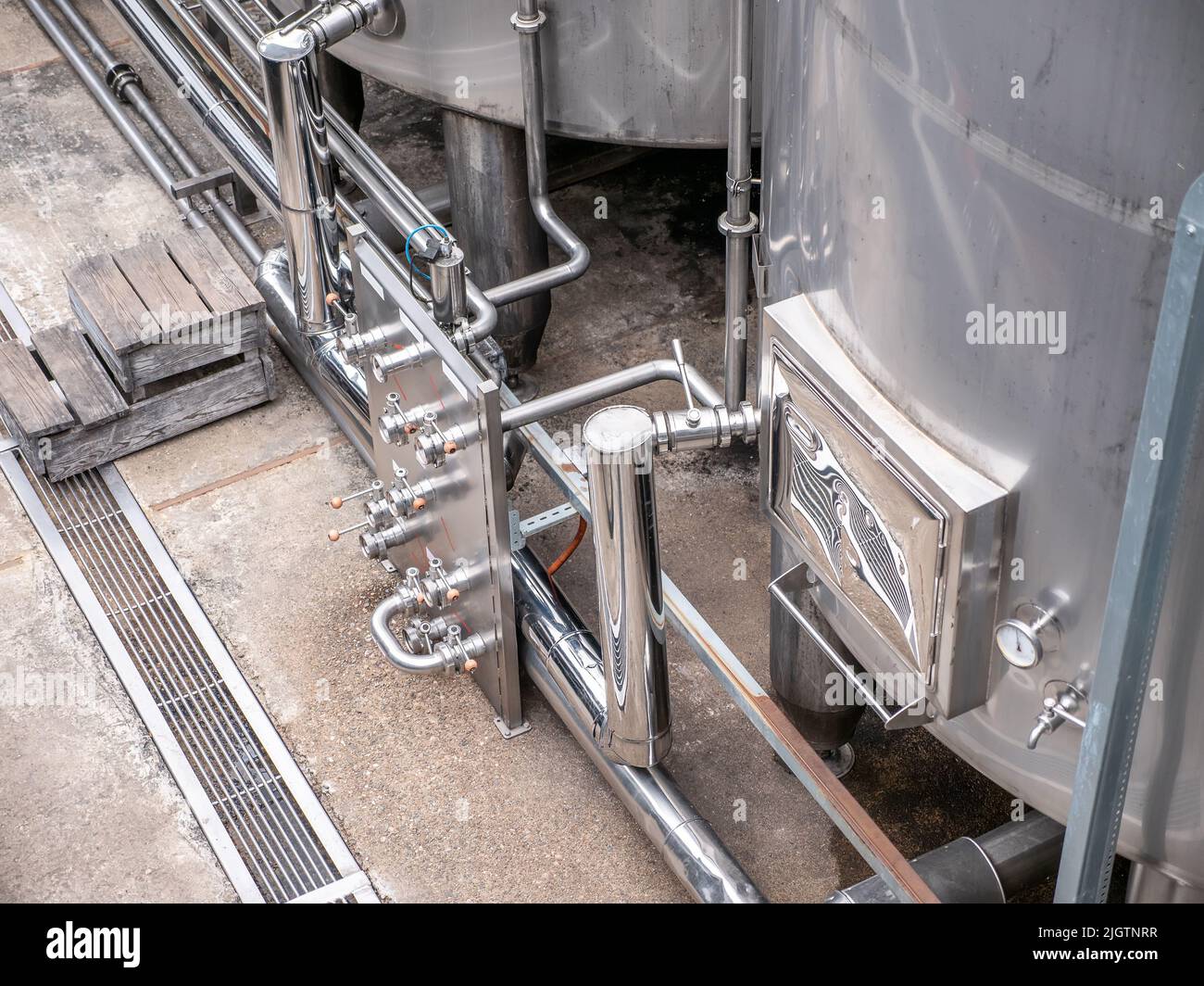 Steel tanks or reservoirs with pipes, food industry. Stock Photo