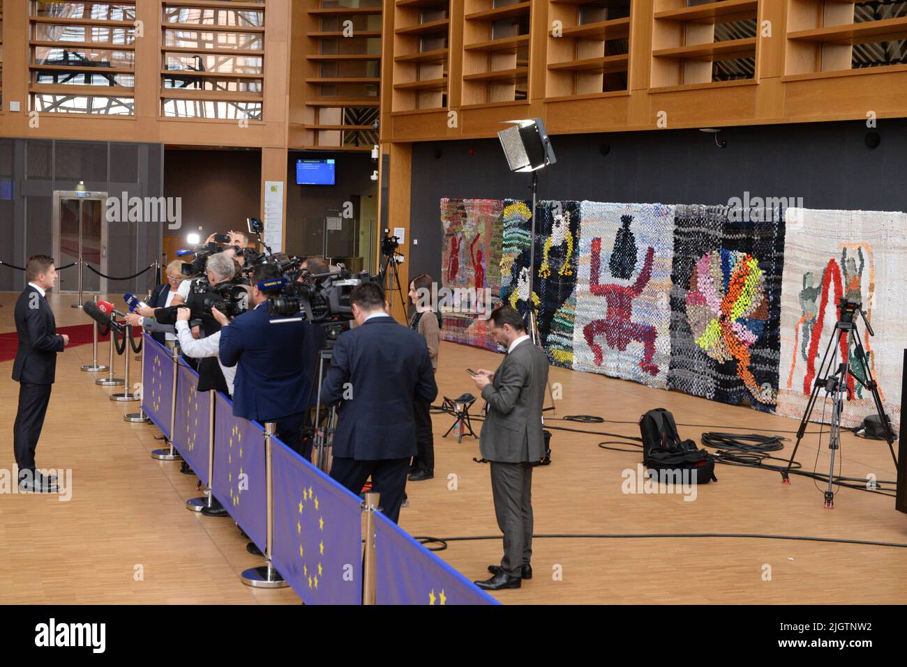 Brussels, Belgium. 12th July, 2022. Health Minister of Croatia Zdravko Maric, left, speaks to journalists in the hall of the Justus Lipsius building in Brussels, Belgium, which was decorated with twelve carpets with floral motifs by Czech artists on the occasion of the Czech EU Presidency, July 12, 2022. Credit: Petr Kupec/CTK Photo/Alamy Live News Stock Photo